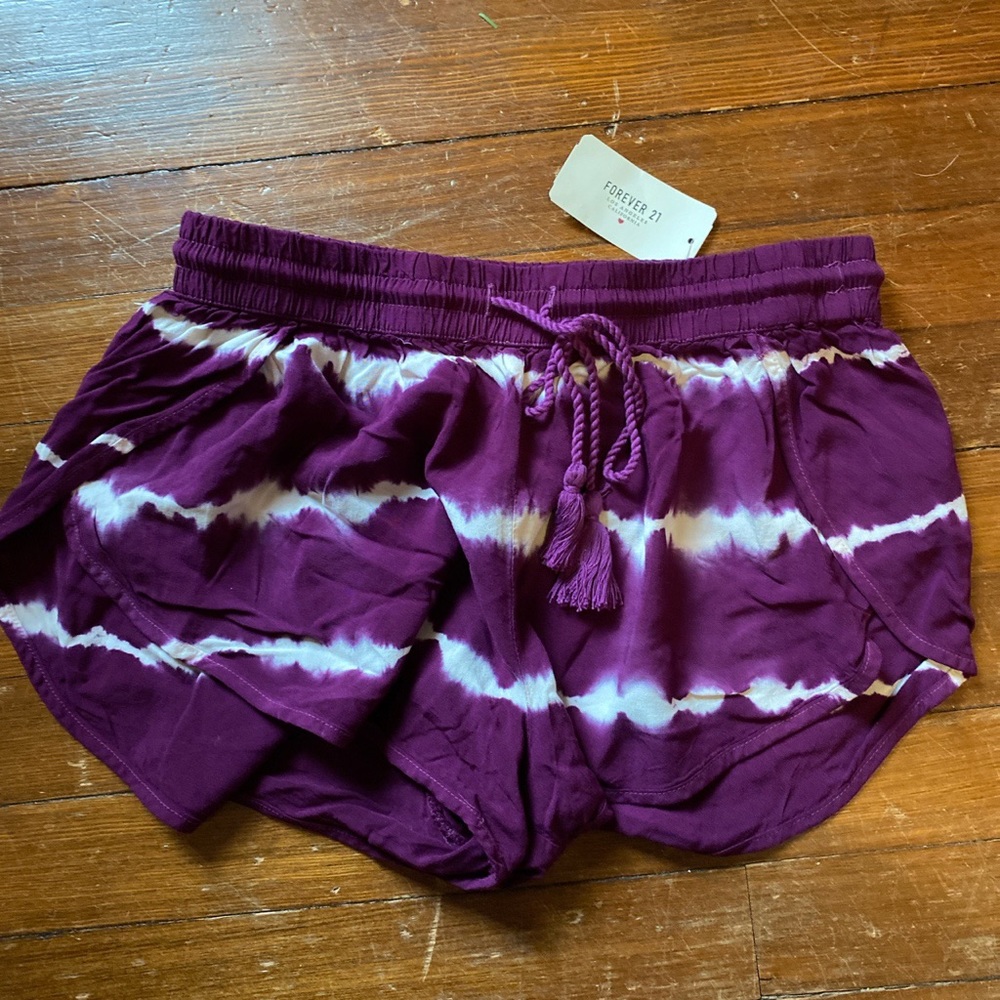 Purple flowy shorts with white stripes